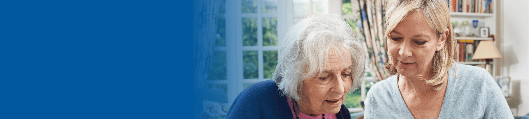 woman helping elderly woman