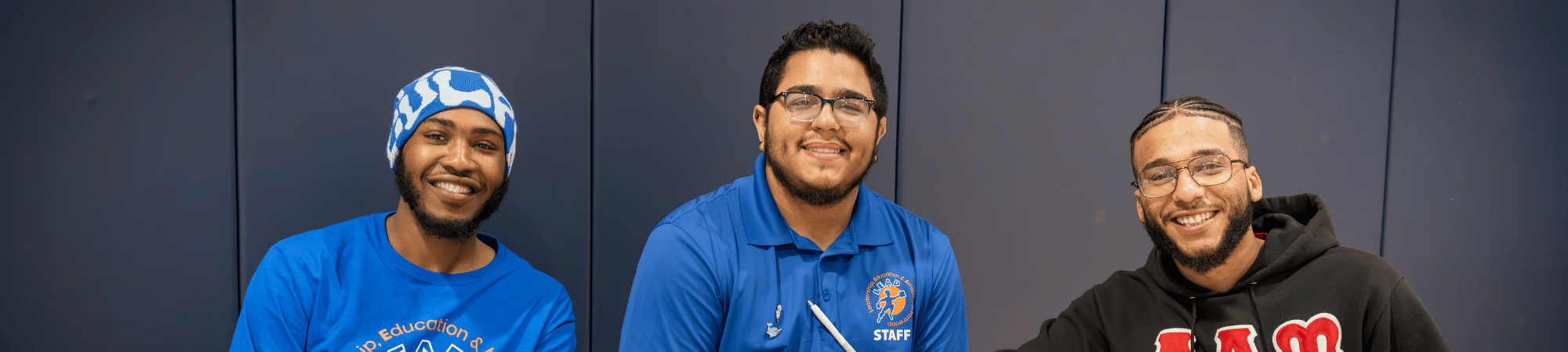 three men smiling at training session