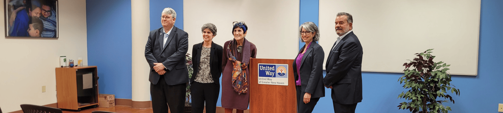 speakers standing in front of community room